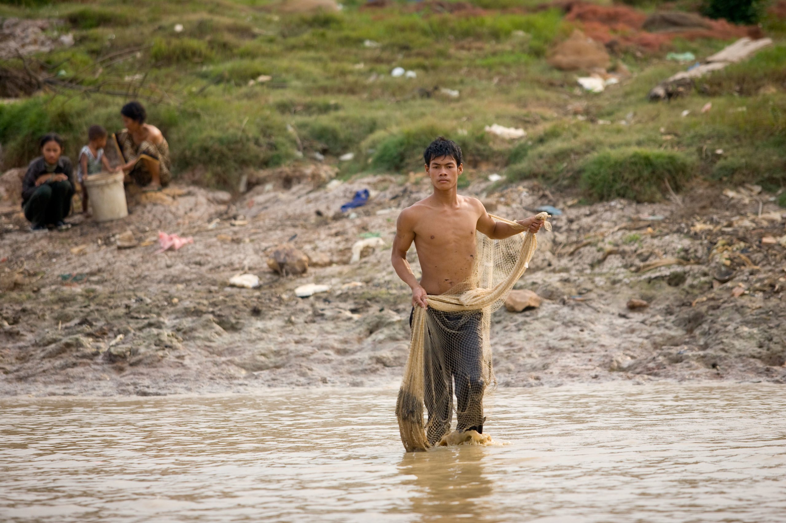 A Cambodia man fishes on the Tonle Sap lake