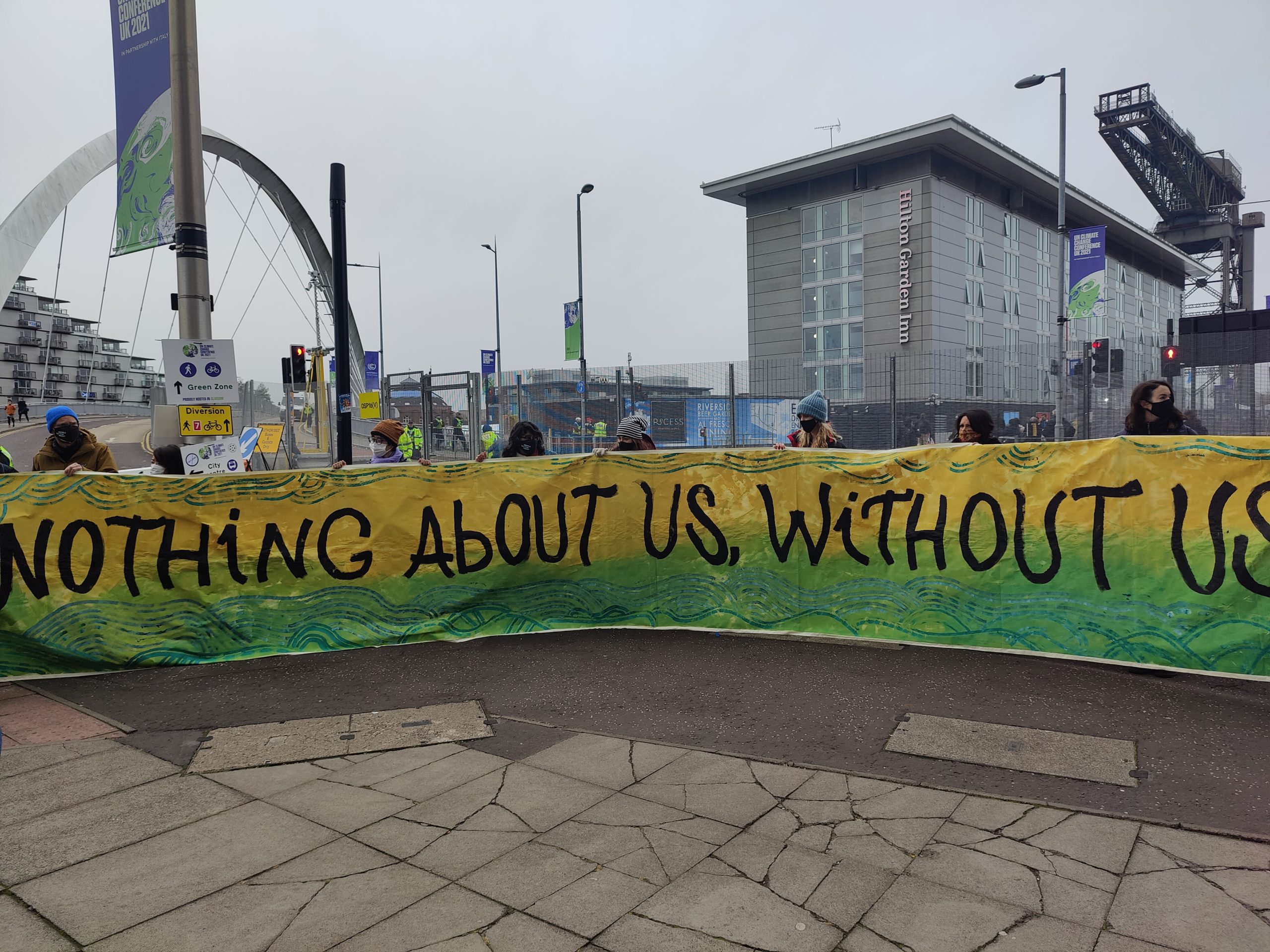 A protest outside the COP26 venue in Glasgow draws attention to the limited representation of civil society from developing countries and indigenous communities (Image: Disha Shetty)