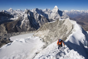 <p>A climber on the summit ridge of a peak in the Solu-Khumbu Everest region in Nepal. Some researchers say the Everest region is ‘now experiencing spring-like conditions’ in winter. (Image: Christian Kober / Alamy)</p>