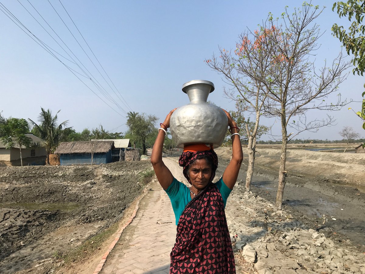 A woman collects water from a pond in Satkhira district, Bangladesh, Abu Siddique