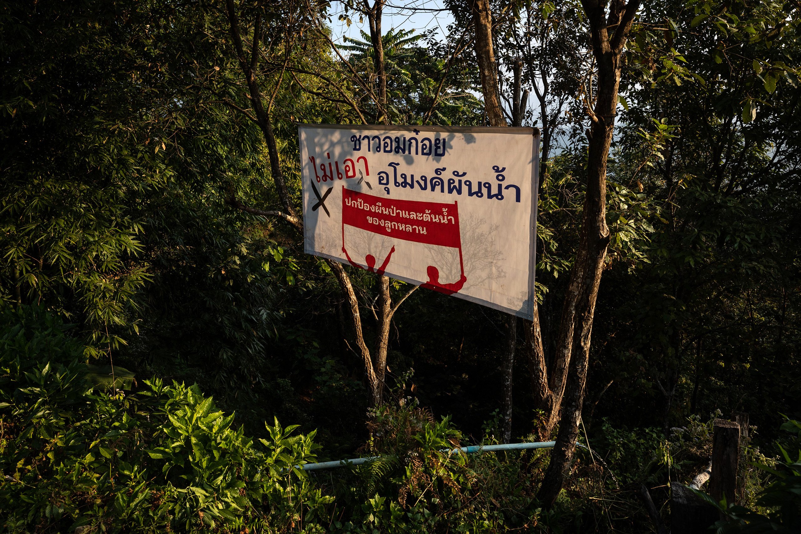 An anti-tunnel banner is hung from trees in Mae Sor village, one of the remotest and traditional villages in Omkoi District 
