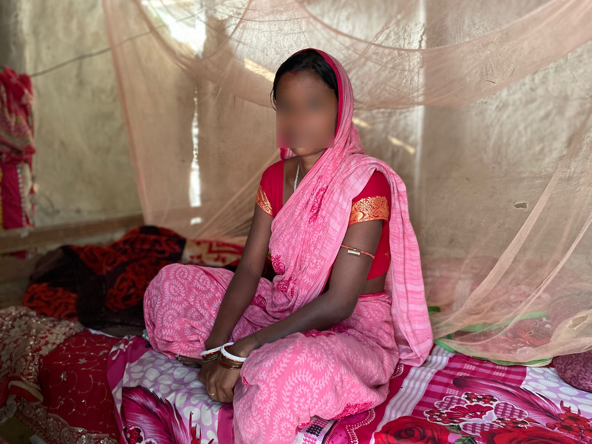 Woman in sari with face blurred to protect identity