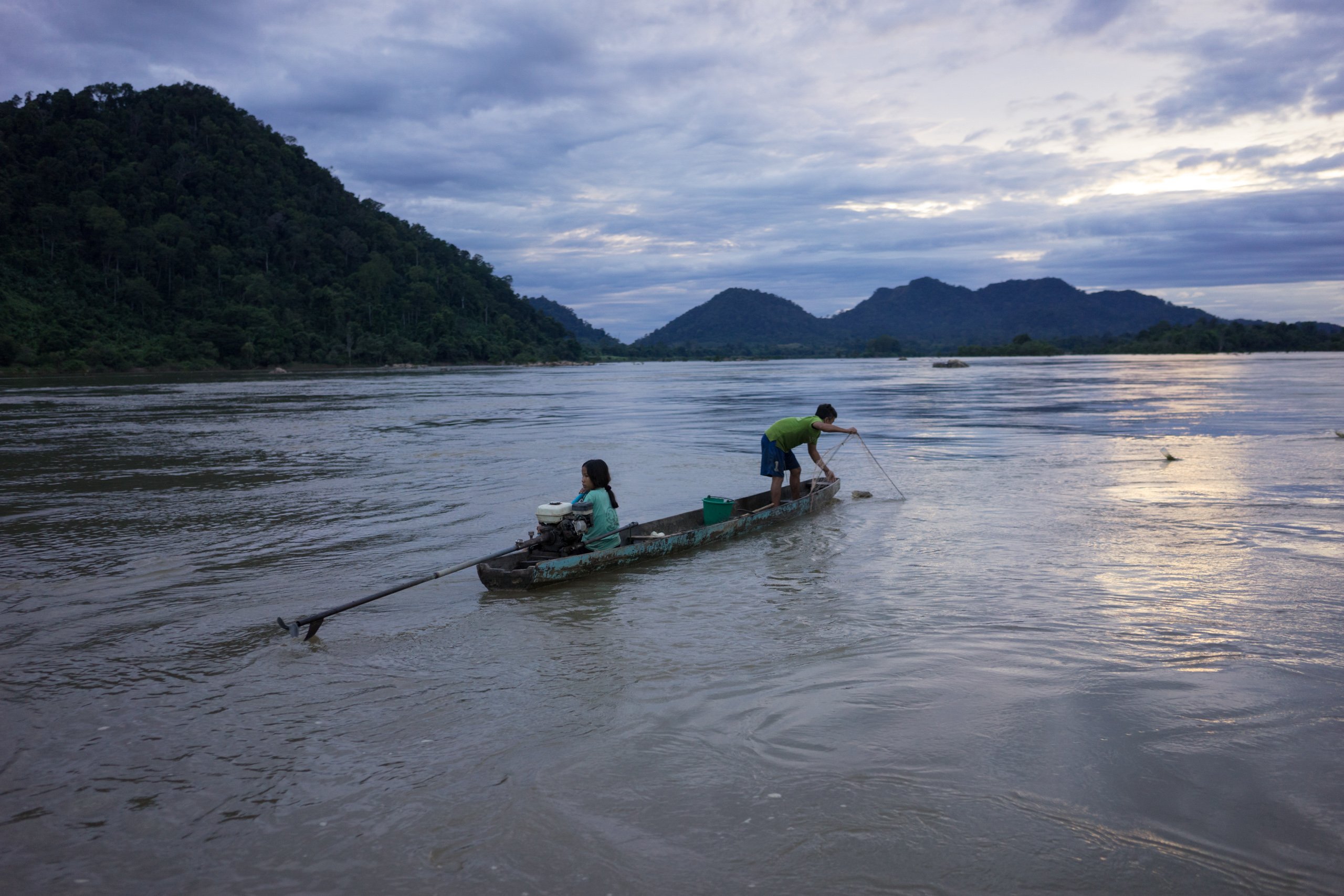 A young fisher lays a gill net in the Chheu Teal pool on the Laos-Cambodia border. The pool’s last dolphin died with netting wrapped around its tail