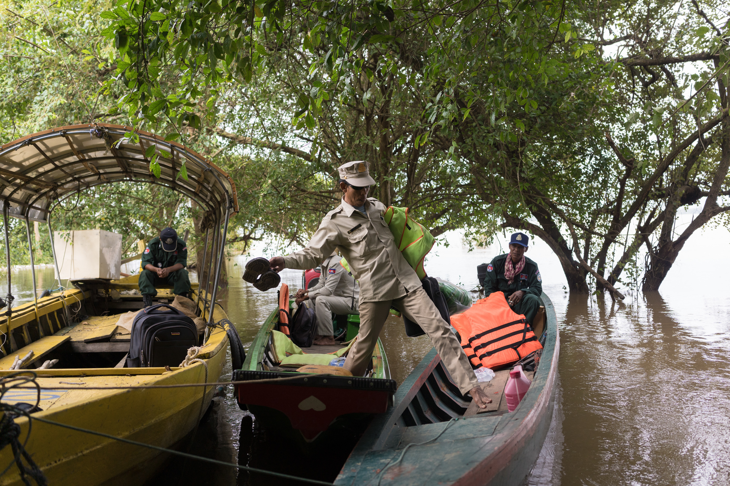 River guards get ready for a patrol of the Kampi pool, Cambodia
