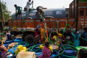<p>People rush to fill up plastic drums with water during a severe drought in Maharashtra, India in April 2016. Global heating has intensified the water cycle, meaning there will be more extreme rainfall and worse droughts in the future, according to the latest IPCC report (Image: Alamy)</p>