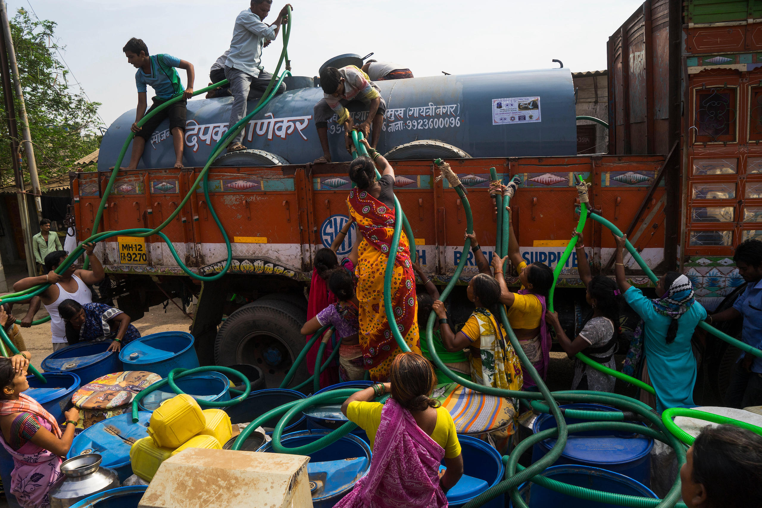 <p>People rush to fill up plastic drums with water during a severe drought in Maharashtra, India in April 2016. Global heating has intensified the water cycle, meaning there will be more extreme rainfall and worse droughts in the future, according to the latest IPCC report (Image: Alamy)</p>