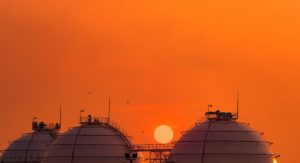 Industrial Gas Storage Tank On Orange Sunset Sky. Lng Or Liquefied Natural Gas Storage Tank on orange sunset sky