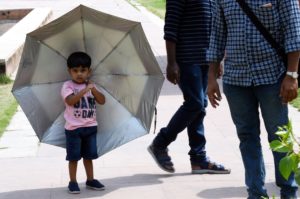 <p>People use umbrellas to shield themselves from the sun in New Delhi on 18 April 2022 (Image: Ravi Batra / Alamy)</p>