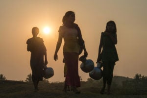 <p>Women walk to collect water in Rakhine State, Myanmar, in 2016. Military rule would likely politicise humanitarian aid in the event of a severe drought, with repercussions for affected populations. (Image: Alamy)</p>