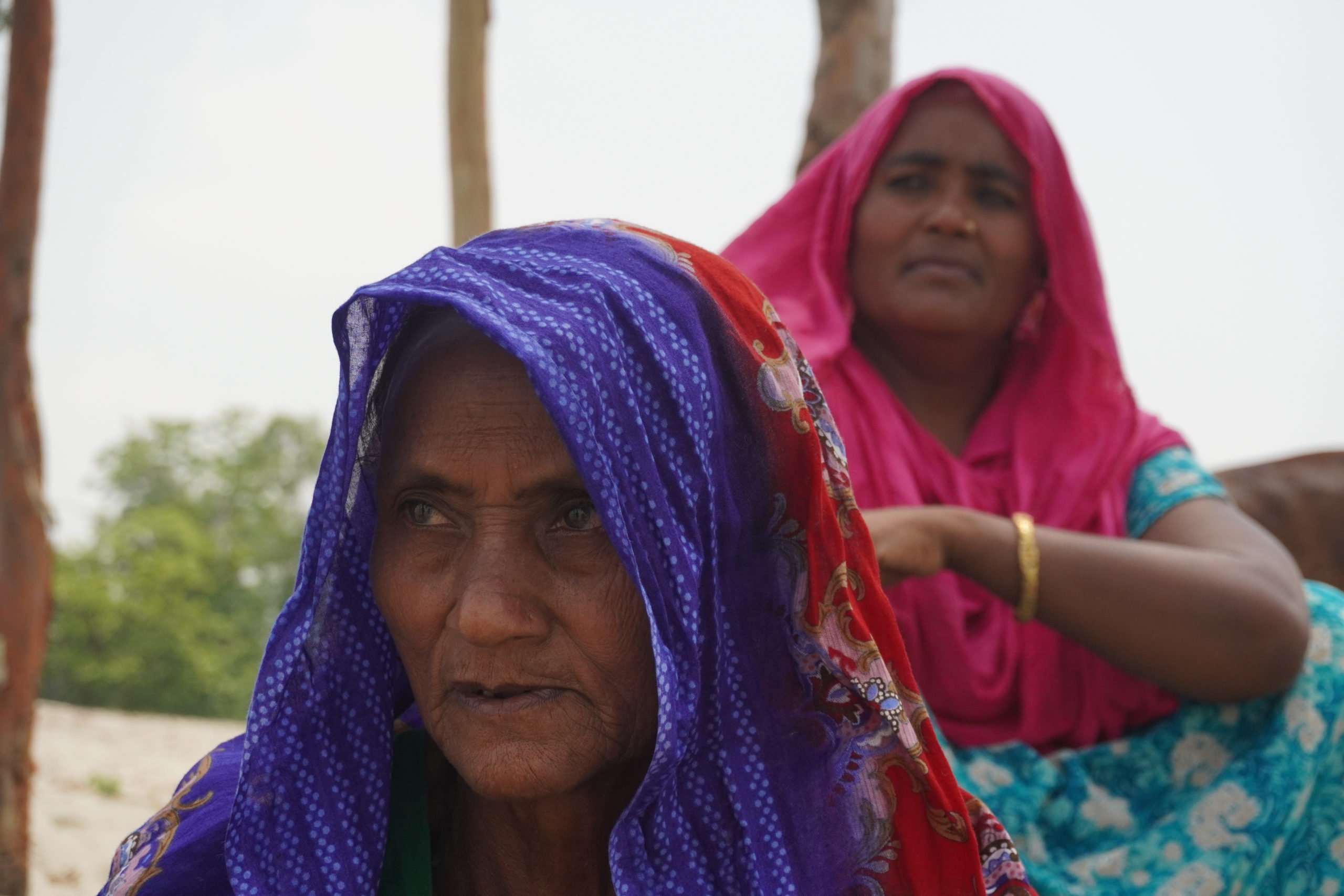 Sukhi Begum with her 50-year-old daughter Bani Begum in the background at her home in Pakuar Char, Jamalpur, Bangladesh