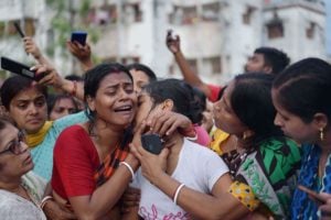 <p>A woman mourns the loss of a family member who was killed in the Manipur landslide on 30 June. Rescuers in the northeastern Indian state have so far pulled 50 bodies from the debris. (Image: Alamy)</p>