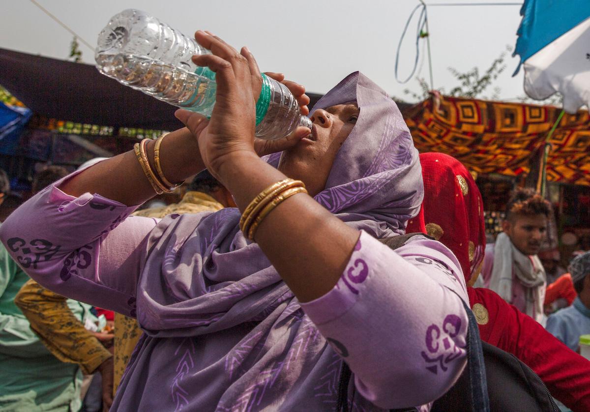 A woman drinks water during heatwave in New Delhi, April 29, 2022