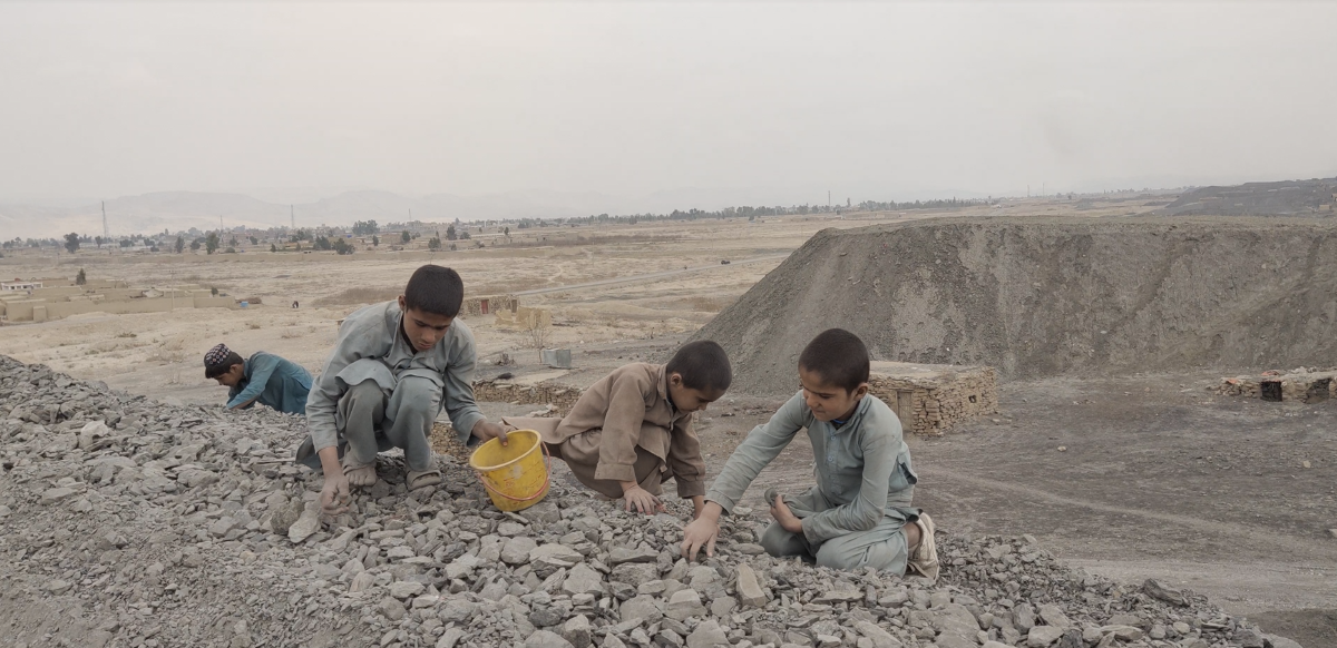 Three children from the coalfield areas of Pakistan collecting coal