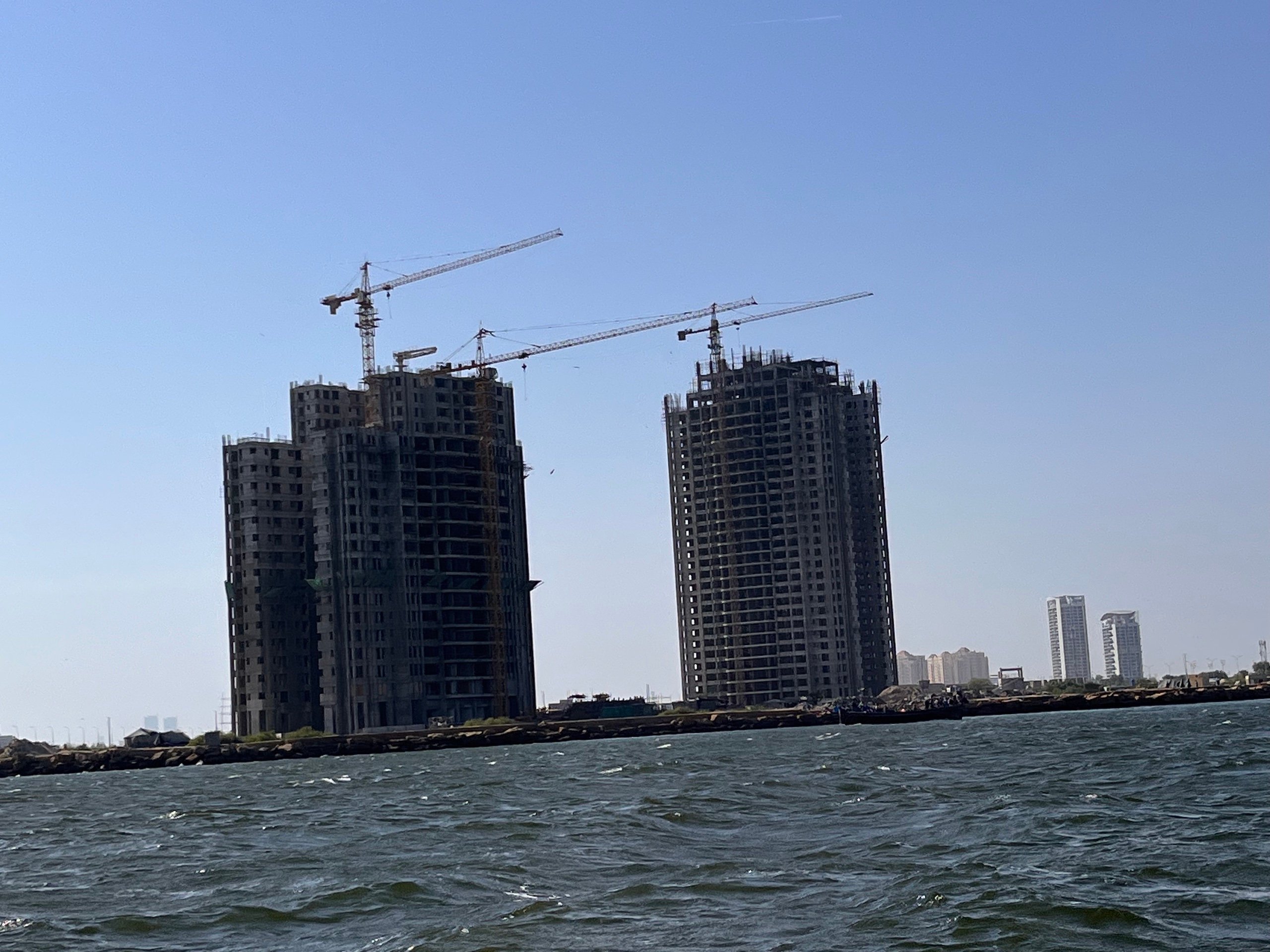 High-rise buildings being built on reclaimed land in DHA's phase 8 development in Karachi in April 2022. The buildings will look out on the Arabian Sea when complete.