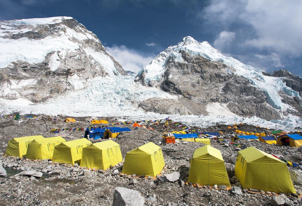 View of yellow tents at mount Everest base camp, looking up at the Khumbu glacier