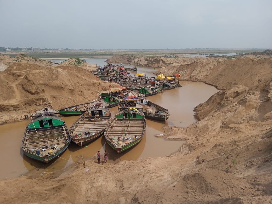 Boats waiting to be loaded with illegally mined sand on the banks of the Sone River in the Bhojpur district, Bihar