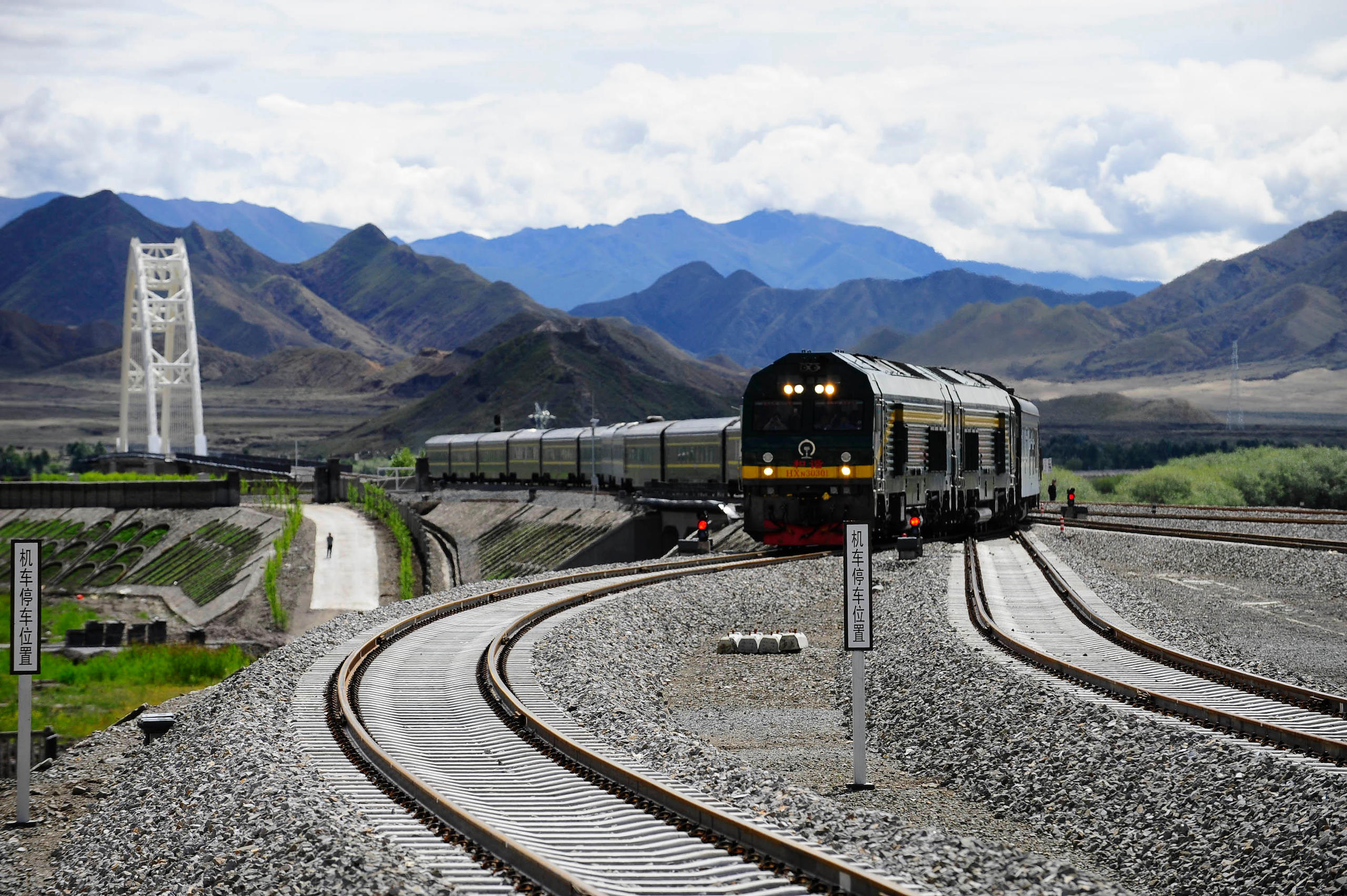 The first passenger train from Lhasa to Xigaze heads into Xigaze railway station, in southwest China, in August 2014.