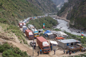<p>A queue of trucks in 2017 in Timure, three kilometres from the Nepal-Tibet border, waiting to get clearance to cross into Tibet. Since an earthquake in Nepal in 2015 this road, passing through Rasuwa Gadhi, has been the only functional route, and is frequently closed due to heavy snow or landslides. (Image: Nabin Baral)</p>
