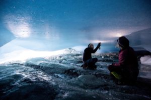 <p>Glaciologists inspect a crack in the ceiling of a natural glacier cavity of the Jamtalferner glacier in Austria. Giant ice caves have appeared in glaciers, accelerating the melting process faster than expected as warmer air rushes through the ice mass until it collapses. (Image: Lisi Niesner / Alamy)</p>