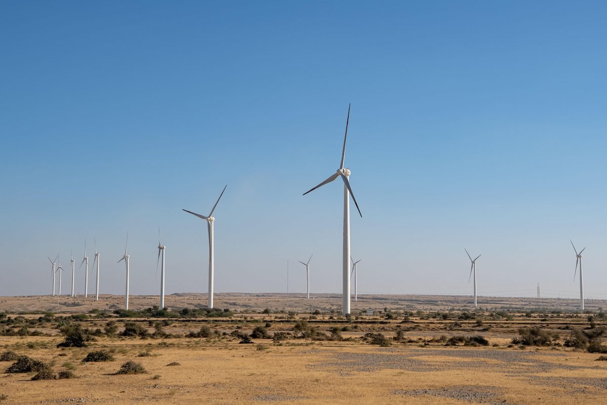 View of wind turbines against a blue sky in Jhimpir, Pakistan