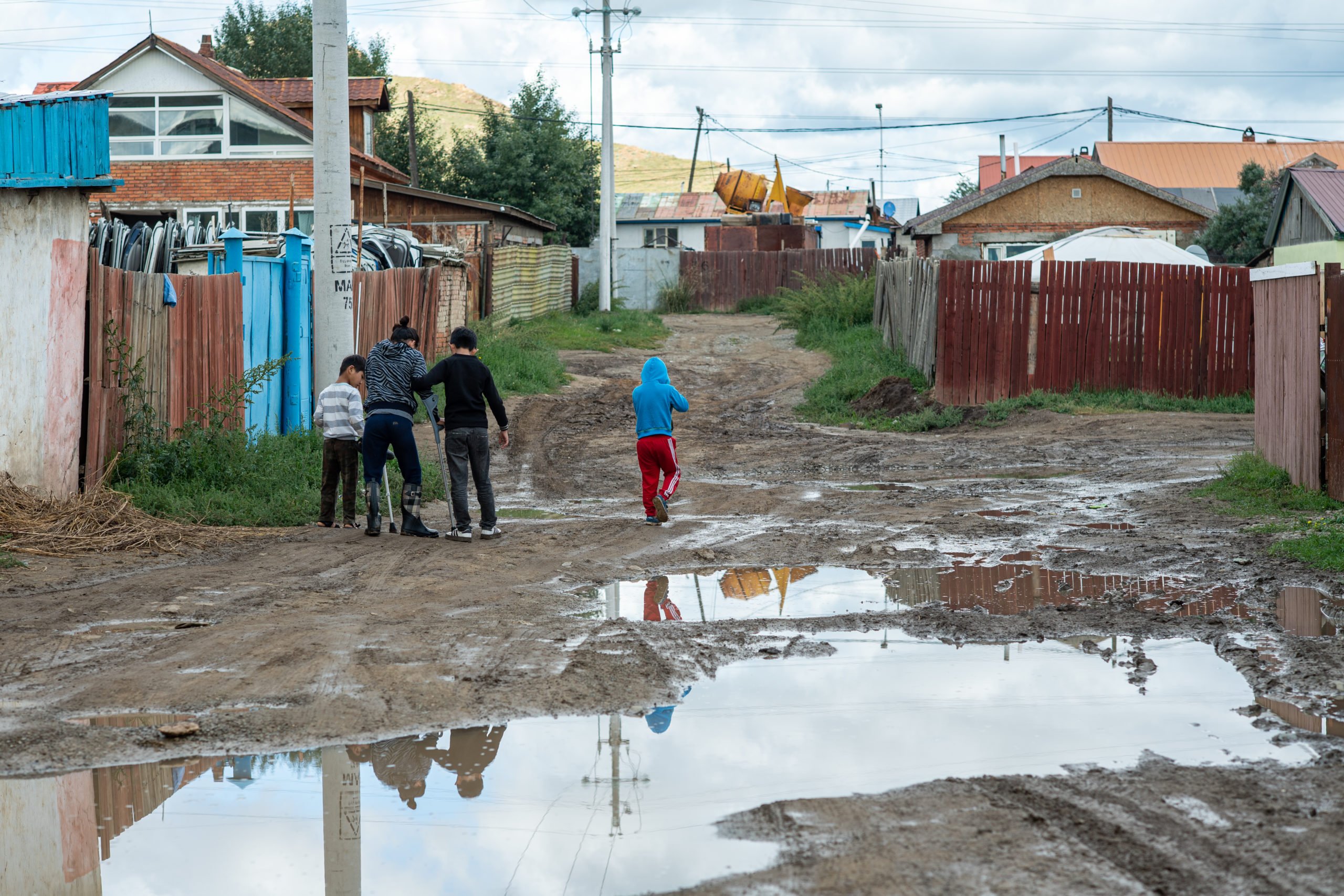 children walking in muddy area