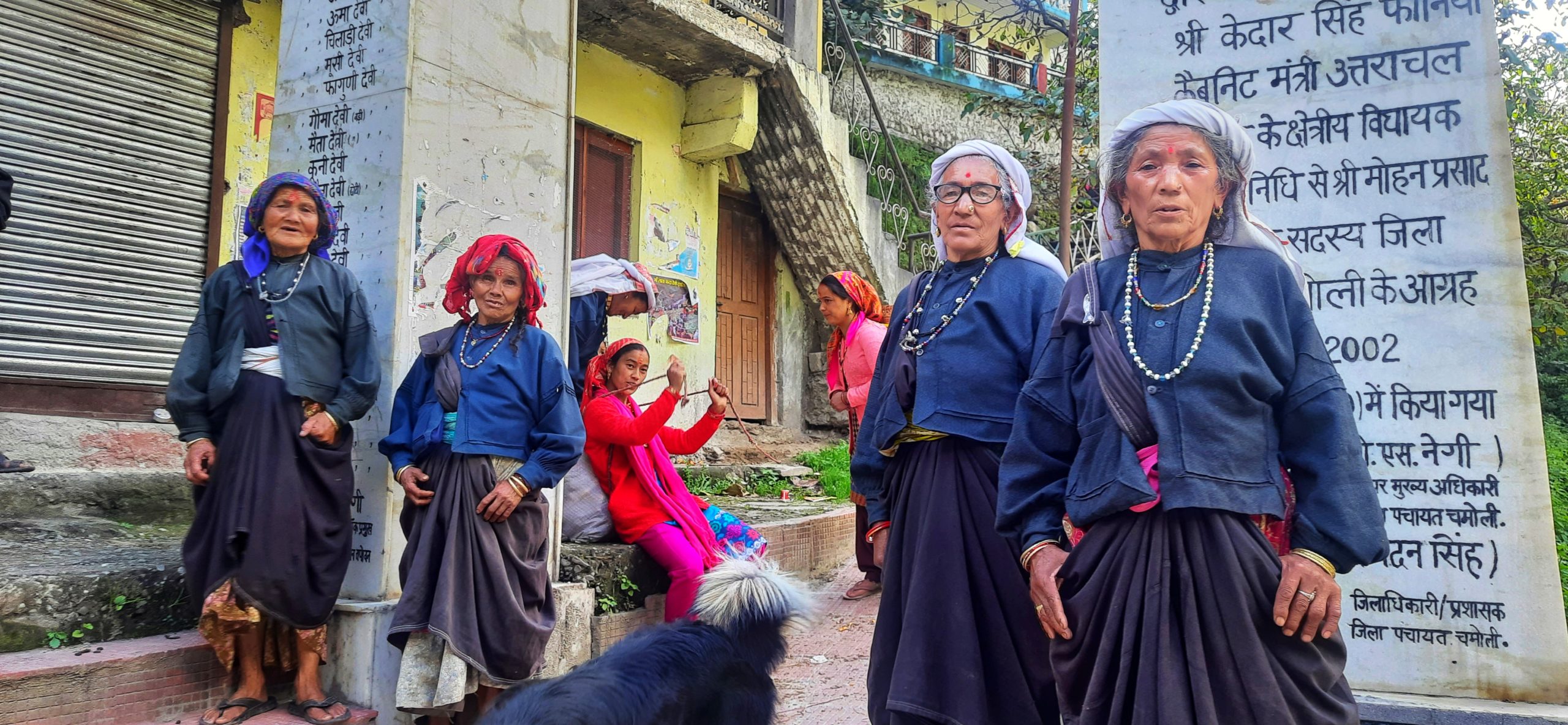group of older women standing on street