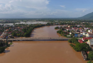 <p>The proposed Phou Ngoy hydropower dam would be located just south of the city of Pakse in Laos, pictured here during a flood in 2018. Experts say the dam would effectively sever a key link between the upper reaches of the Mekong and biodiverse floodplains to the south. (Image: Liu Ailun / Alamy)</p>