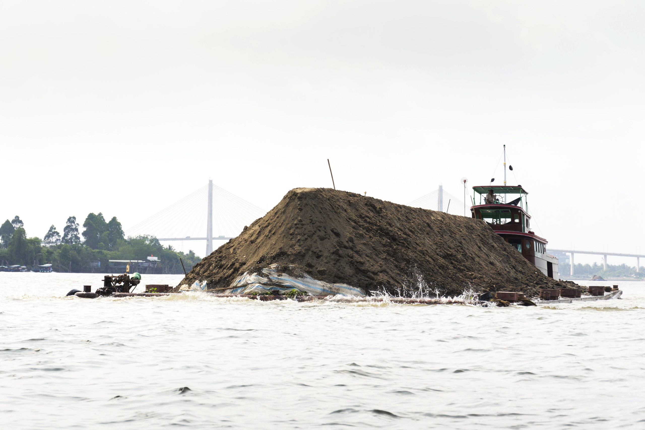 <p>Dredged sand is transported in the Mekong Delta, Vietnam. The Mekong Delta is sinking due to unsustainable sand mining and the impacts of upstream dams. (Image: Josef Kubes / Alamy)</p>