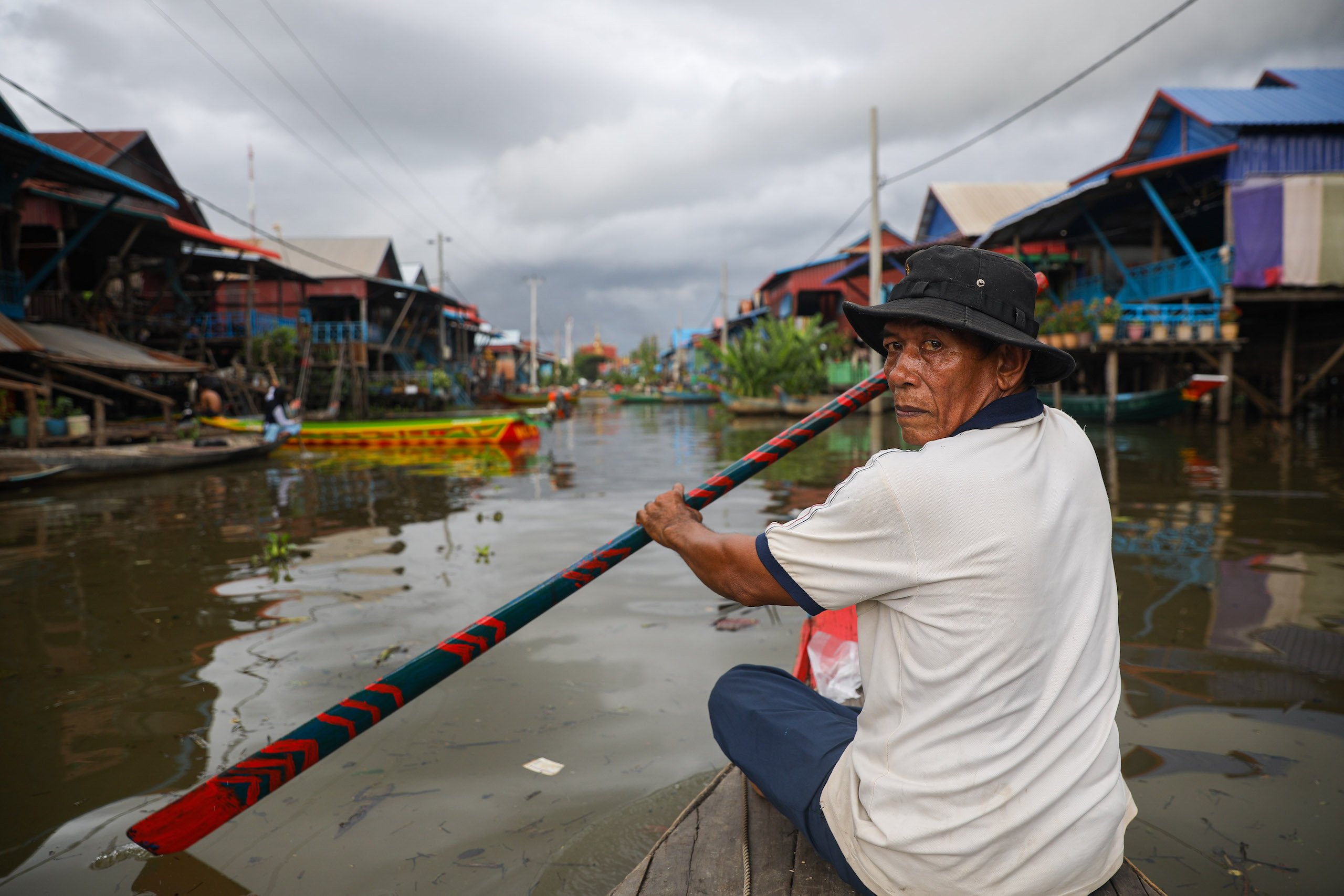 Boatman Meas Sareth paddles through the heart of Kampong Phluk, a floating village on Cambodia’s Tonle Sap Lake