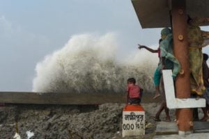 <p>Waves crash against a tidal barrier as Cyclone Yaas makes landfall in Bakkhali Island, West Bengal, May 2021 (Image: Arijit Naiya / Alamy)</p>