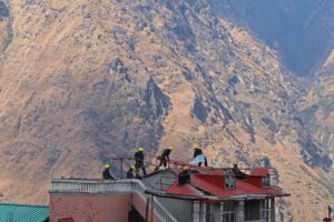 <p>National Disaster Response Force workers demolish a hotel after cracks developed on the property, in Joshimath, northern India, in January 2023. The Himalayas are commonly perceived as ramparts of stone, but it is the water in the glaciers, rivers and aquifers that holds the mountains together. (Image: Anushree Fadnavis / Alamy)</p>