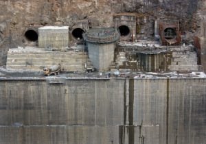 <p>Construction work in December 2017 on one of the Punatsangchhu hydroelectric power projects. The two plants, the largest to be built in Bhutan, were meant to be completed by 2020, but have been significantly delayed, costing more than a billion dollars. (Image: Hazel McAllister / Alamy)</p>