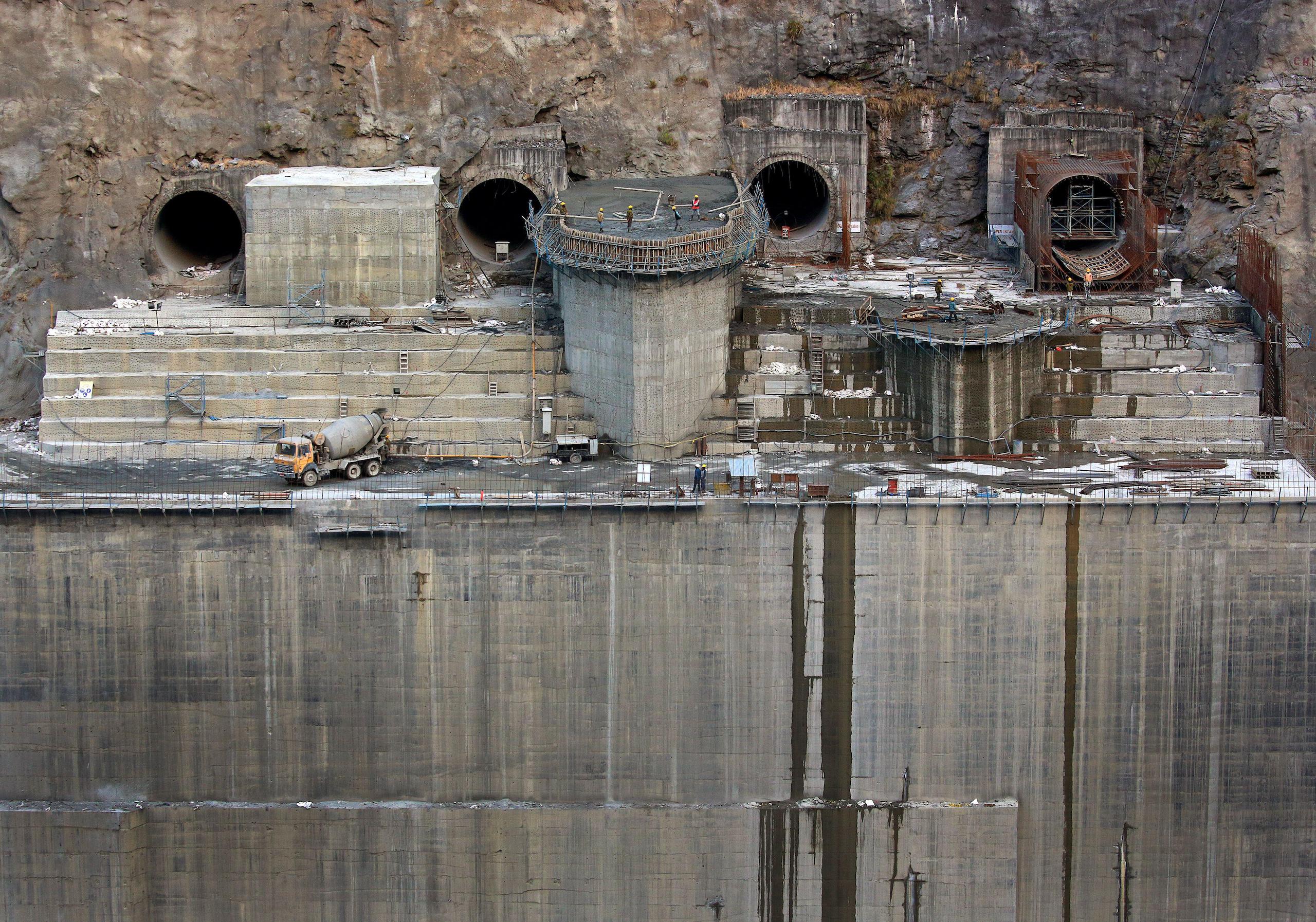 <p>Construction work in December 2017 on one of the Punatsangchhu hydroelectric power projects. The two plants, the largest to be built in Bhutan, were meant to be completed by 2020, but have been significantly delayed, costing more than a billion dollars. (Image: Hazel McAllister / Alamy)</p>