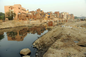 An open water body contains household waste in New Delhi, India