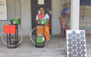 <p>Silk spinner Budhari Goyari at home in Bhaoragwaja village, Assam, with her ‘Silky Spin’ solar-powered machine. The machine was distributed by her local Krishi Vigyan Kendra (agricultural education centre) in 2019. (Image: Courtesy of Sri Ghana Kanta Brahma)</p>