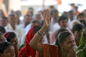 <p>A woman raises her hand to speak at a community meeting in Aurangabad, India, 2009 (Image: <a href="https://www.flickr.com/photos/worldbank/3492673802/in/album-72157633529161411/">Simone D. McCourtie</a> / <a href="https://www.flickr.com/people/worldbank/">World Bank</a>, <a href="https://creativecommons.org/licenses/by-nc-nd/2.0/">CC BY-NC-ND</a>)</p>