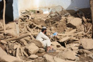 <p>A man sits among ruins after deadly floods in Wardak province, central-eastern Afghanistan, on July 23 (Image: Saifurahman Safi / Alamy)</p>