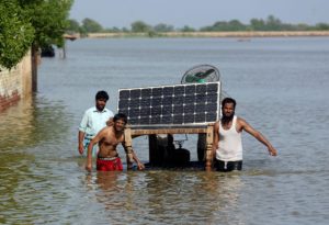<p>Residents of Jaffarabad salvage a solar panel from their flooded home in September 2022. Pakistan&#8217;s National Adaptation Plan sets out how the government intends to equip citizens with the means to protect themselves from climate changed-induced disasters, though observers say large parts are &#8216;identical&#8217; to existing policy. (Image: Fareed Khan / Alamy)</p>