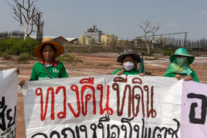 <p>Villagers in north-east Thailand’s Dan Khun Thot district hold banners to protest against the pollution of their soil and water sources, which they blame on a nearby potash mine (Image: <a href="https://www.lukeduggleby.com/">Luke Duggleby</a> / China Dialogue)</p>